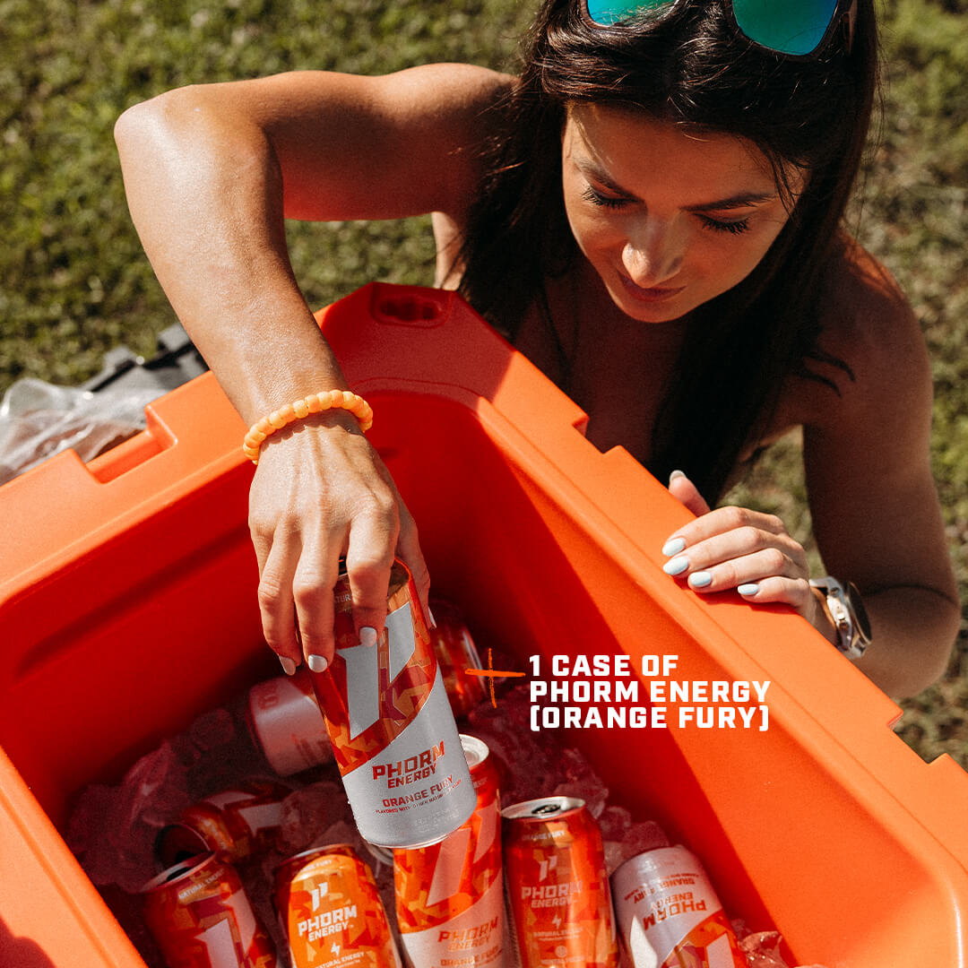 A woman reaches into an orange cooler, taking a can of Phorm Energy Orange Fury from the ice.