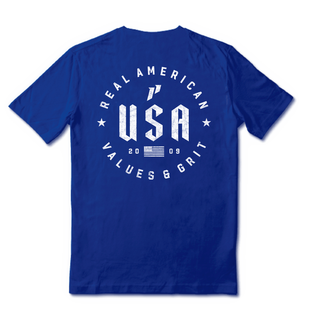 Back of a royal blue t-shirt with a white circular graphic that reads 'Real American Values & Grit USA'.