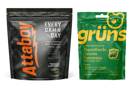 A black pouch of Attaboy supplement next to a green pouch of grüns Superfoods Greens Gummies.
