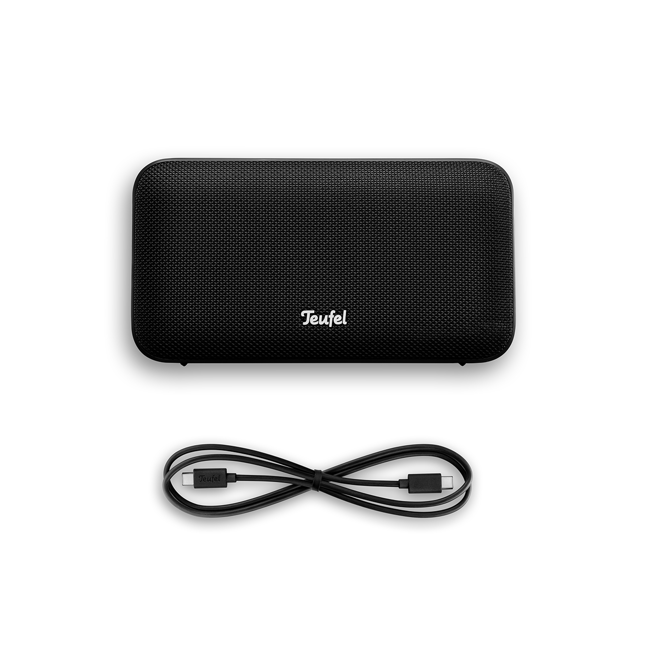 A black Teufel portable speaker and its USB-C charging cable against a white background.