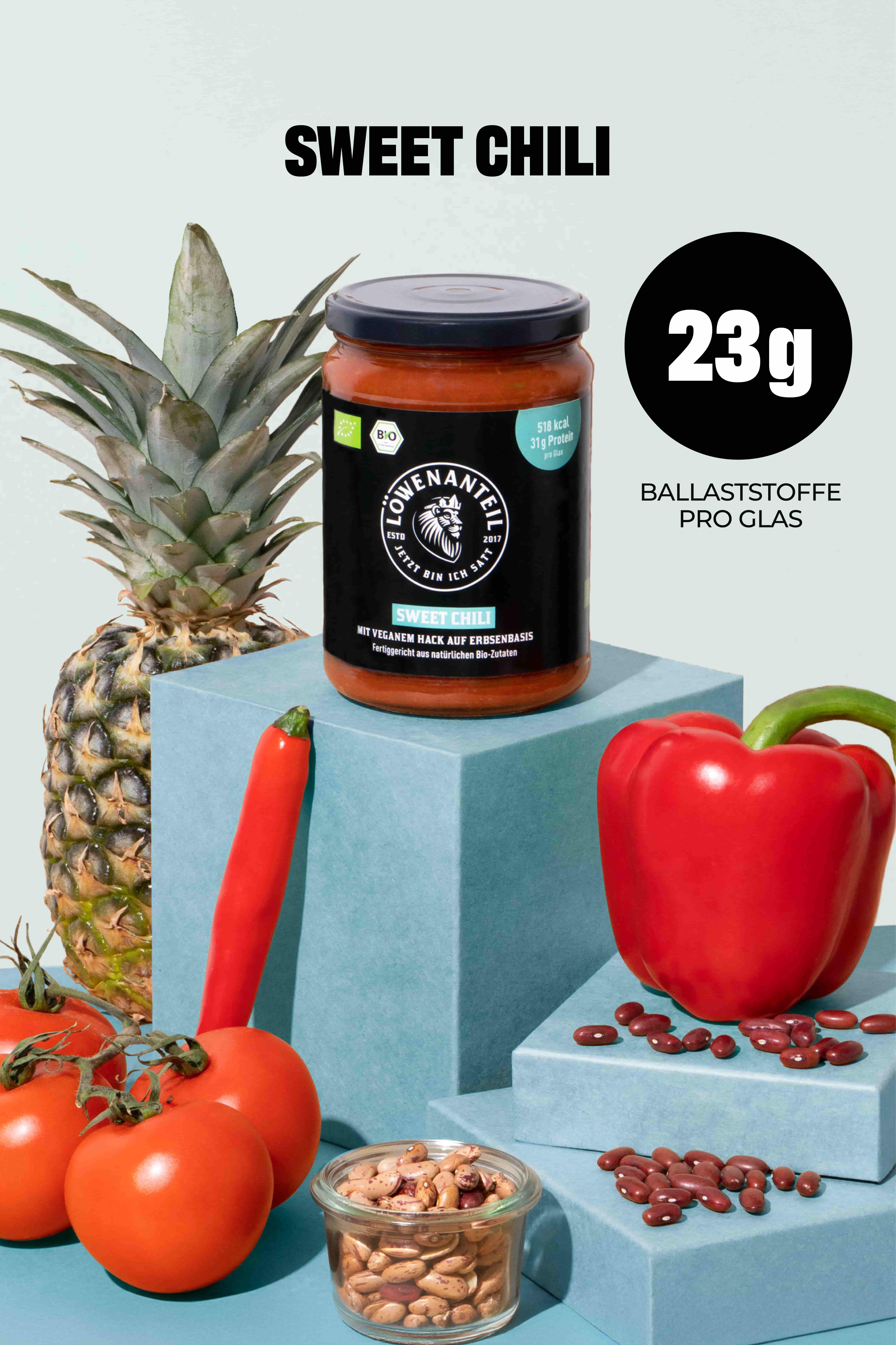 A jar of Löwenanteil Sweet Chili sauce with pineapple, peppers, tomatoes, and beans on blue blocks.