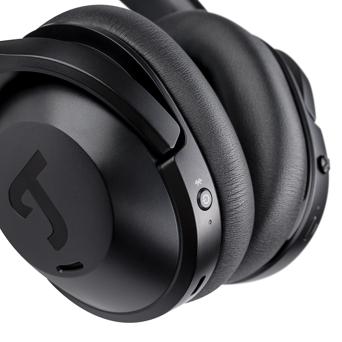 A close-up shot of a pair of black over-ear headphones against a white background.