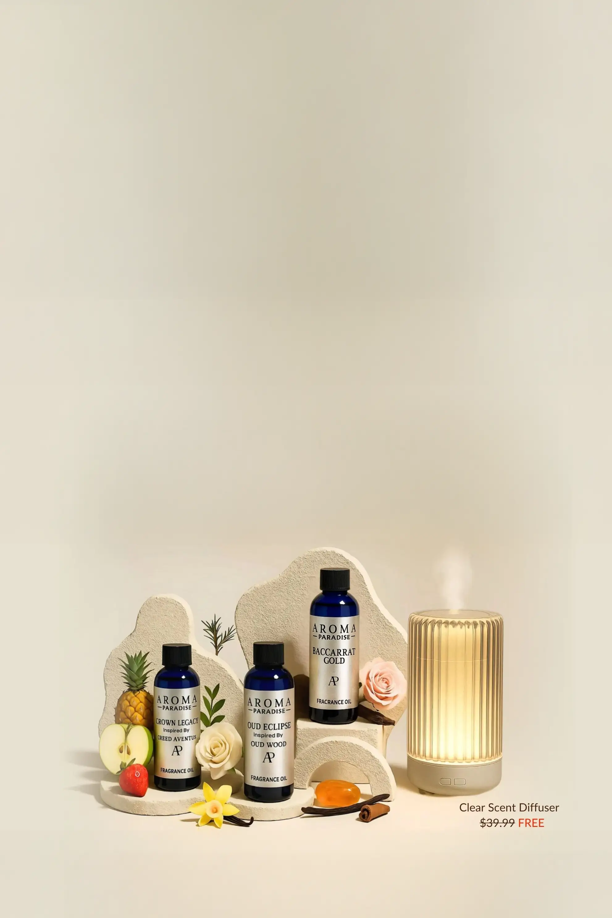 Three fragrance oil bottles with fruits and a diffuser on display.