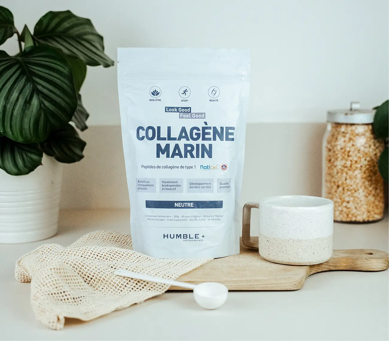 A pouch of Humble+ Marine Collagen powder sits on a kitchen counter with a mug and a scoop.