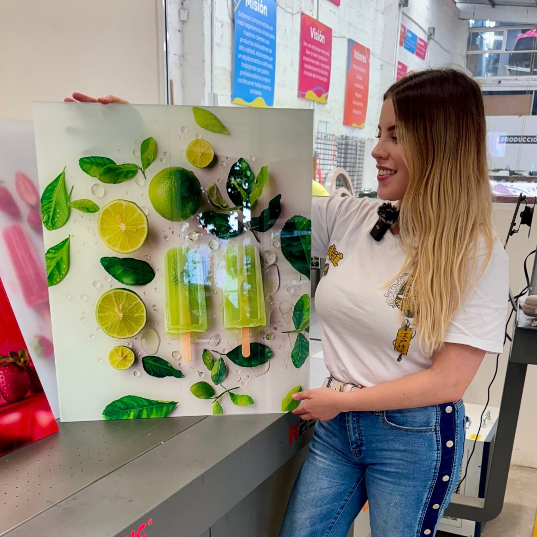 Woman holding a poster of lime popsicles with leaves and limes.