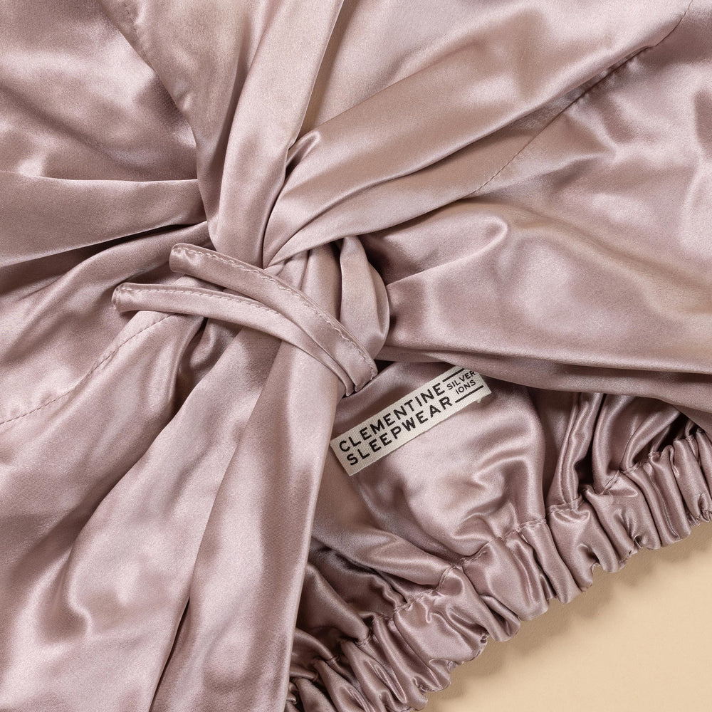 Close-up of silky fabric with a label reading 'Clementine Sleepwear.'