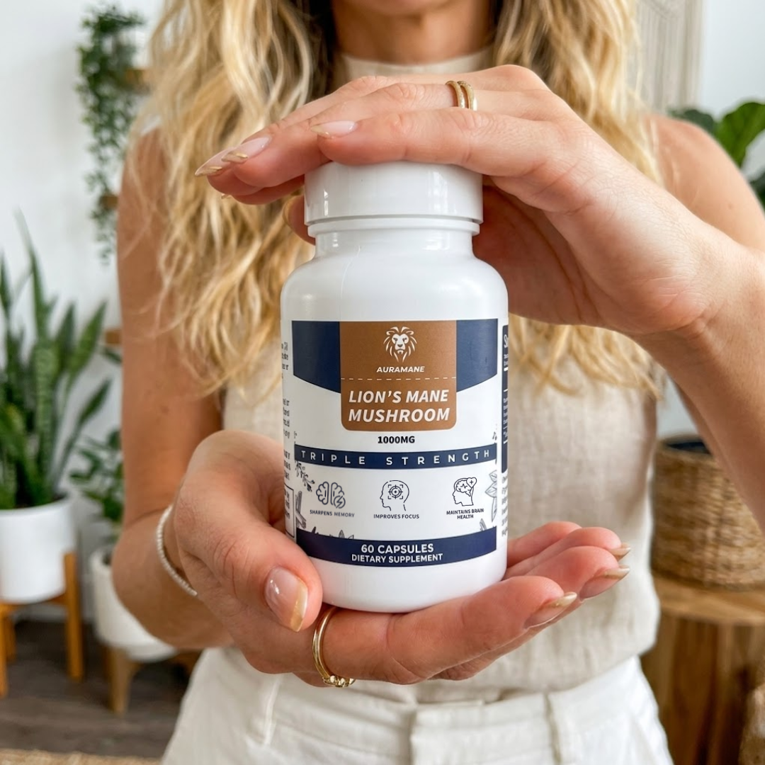 A woman holds a white bottle of Auramane Lion's Mane Mushroom dietary supplement.