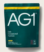 Green AG1 nutrition supplement pouch with yellow stripe and text.