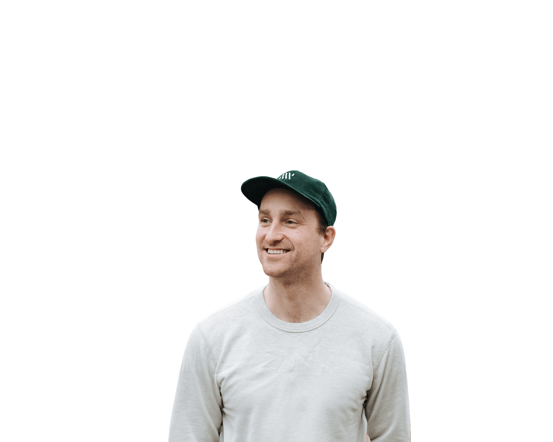 Person wearing a white shirt and a dark green cap, smiling against a plain background.