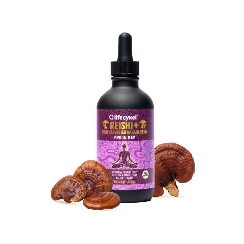 Bottle of Reishi extract with mushrooms around it on a white background.