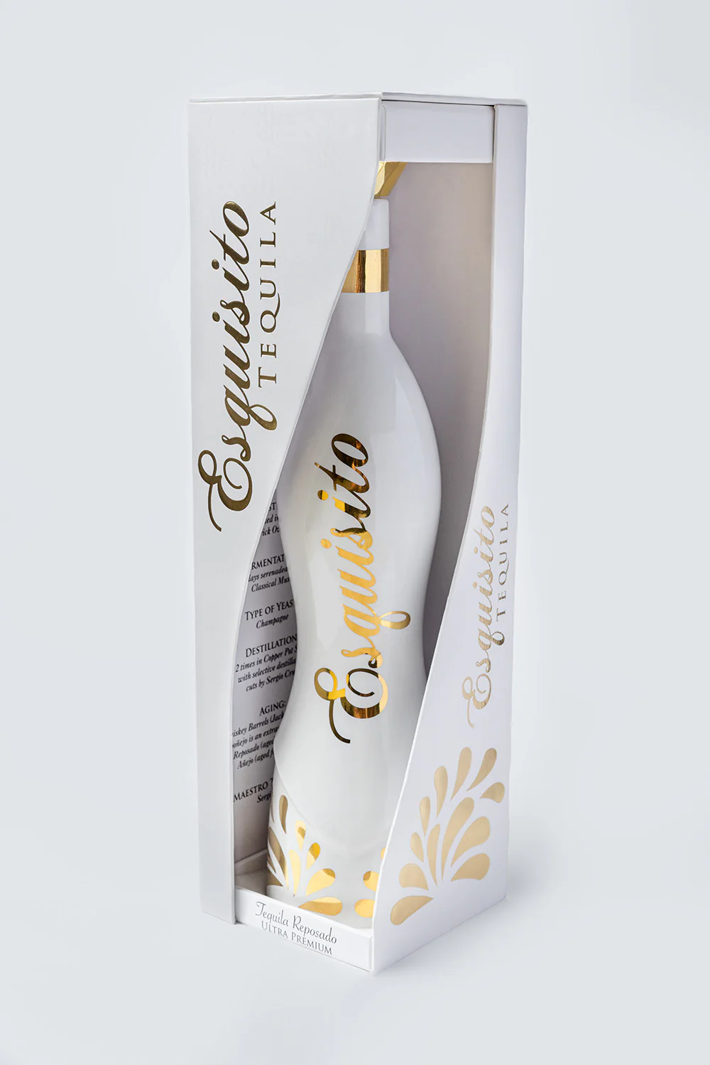 White bottle of Esquisito Tequila in decorative packaging.
