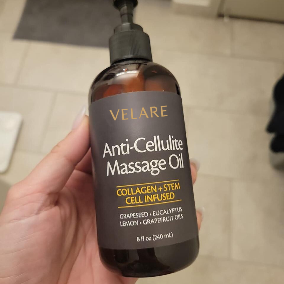 Hand holding a bottle of Velare anti-cellulite massage oil.