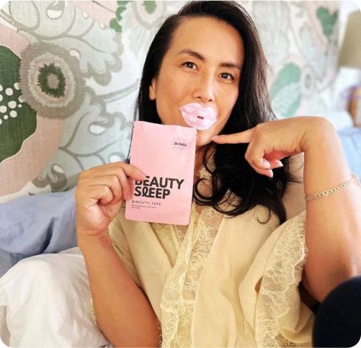 Person with lip mask and holding a 'Beauty Sleep' product package.