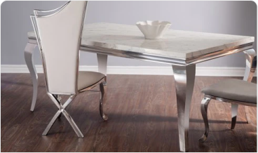 Modern dining table with two chairs and a decorative bowl on top.