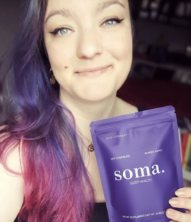 Person with colorful hair holding a purple Soma Sleep Health package.