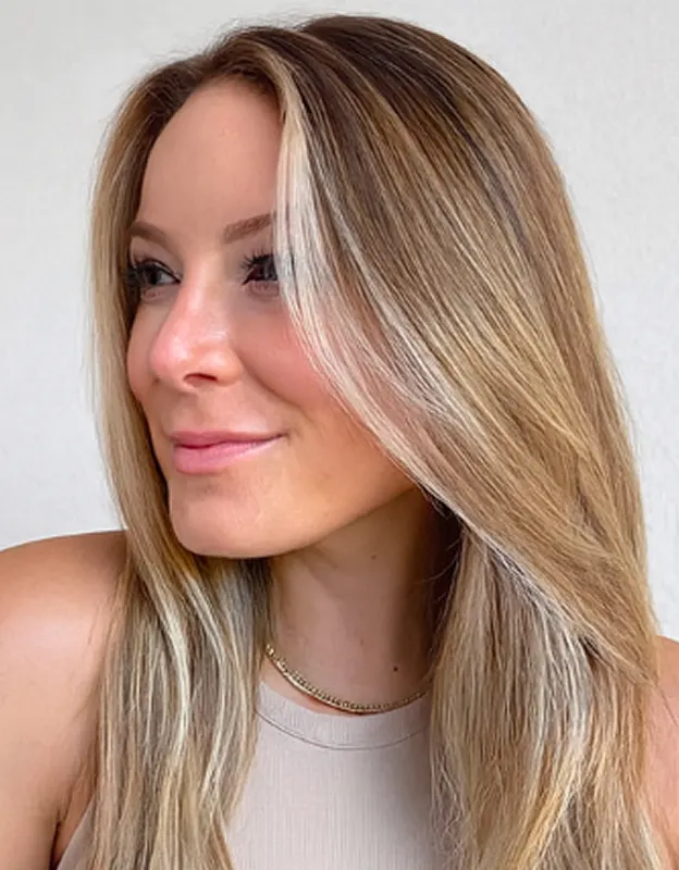 Person with long blonde hair looking to the left.