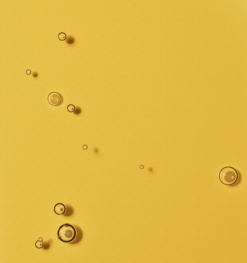 A close-up shot of small bubbles suspended in a golden-yellow liquid.