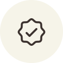 Dark checkmark inside a star-shaped icon on a beige background.