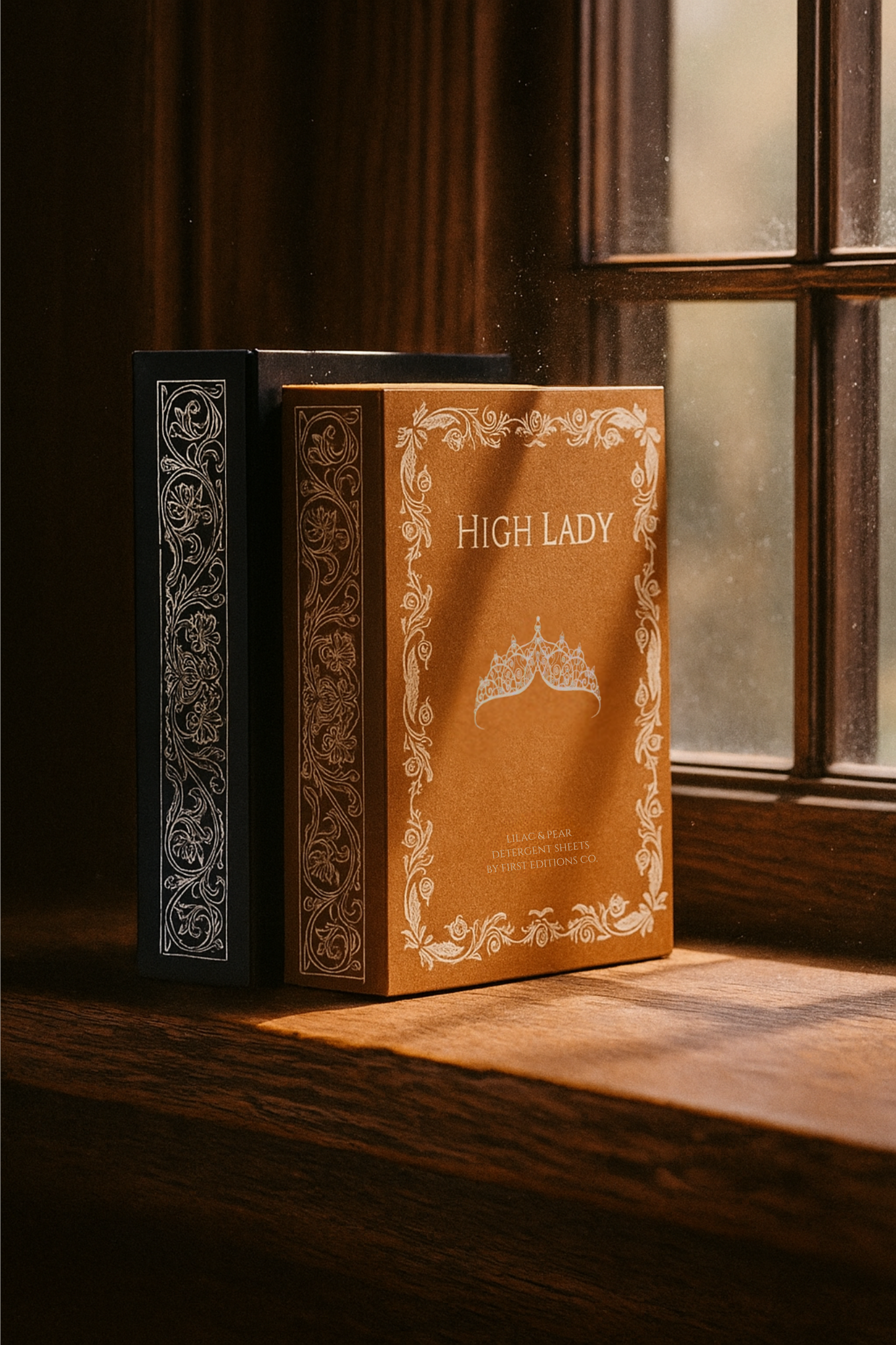 Two decorative books on a wooden windowsill.
