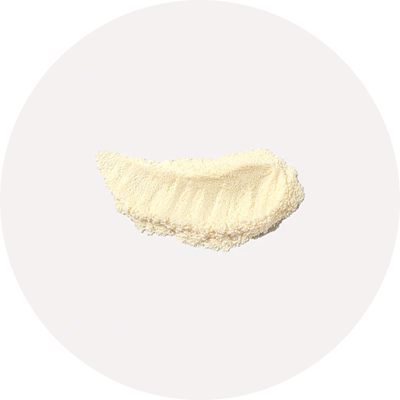 A small pile of beige powder on a white background.