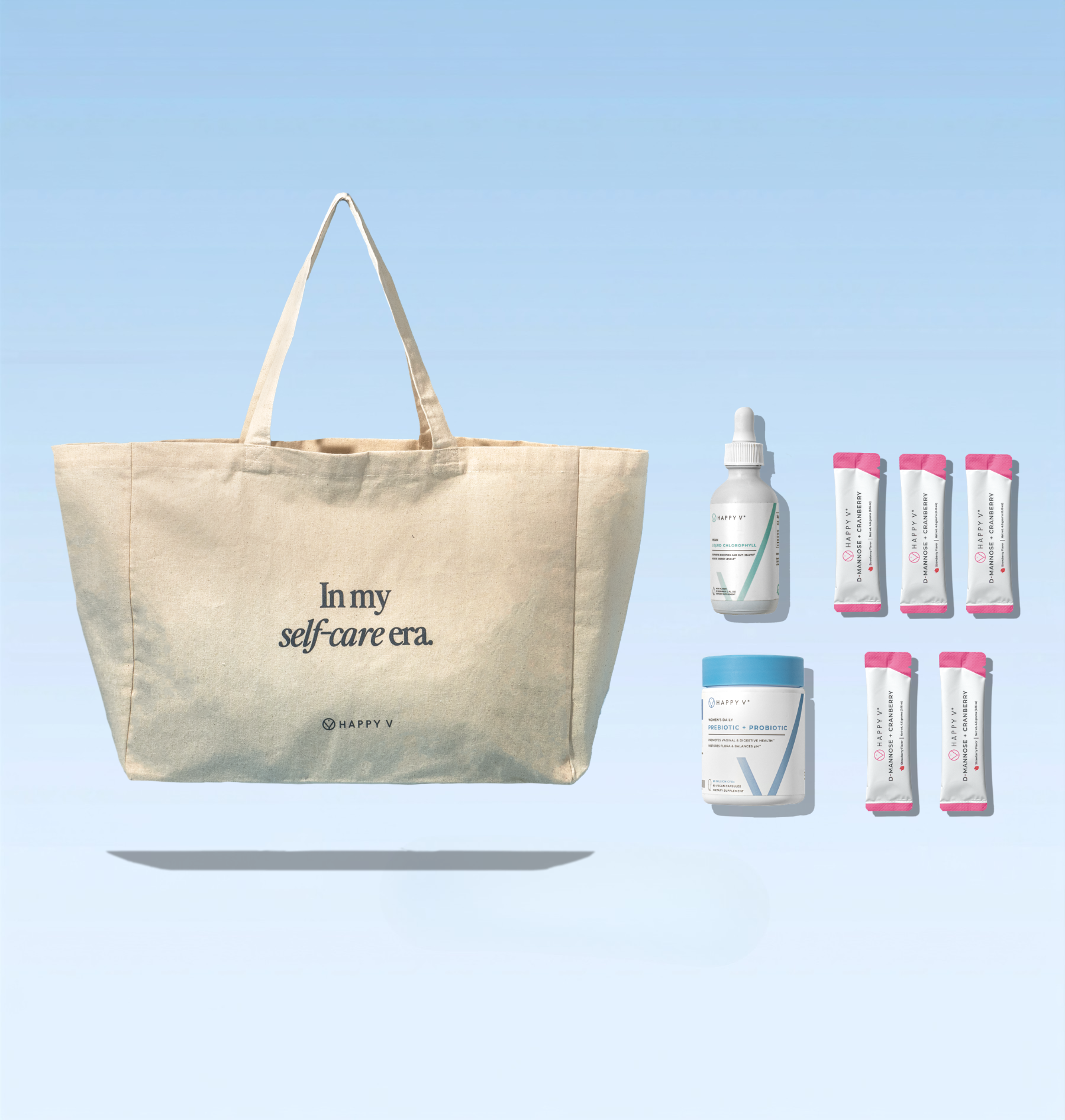 A canvas tote bag that reads 'In my self-care era' next to various Happy V wellness products.
