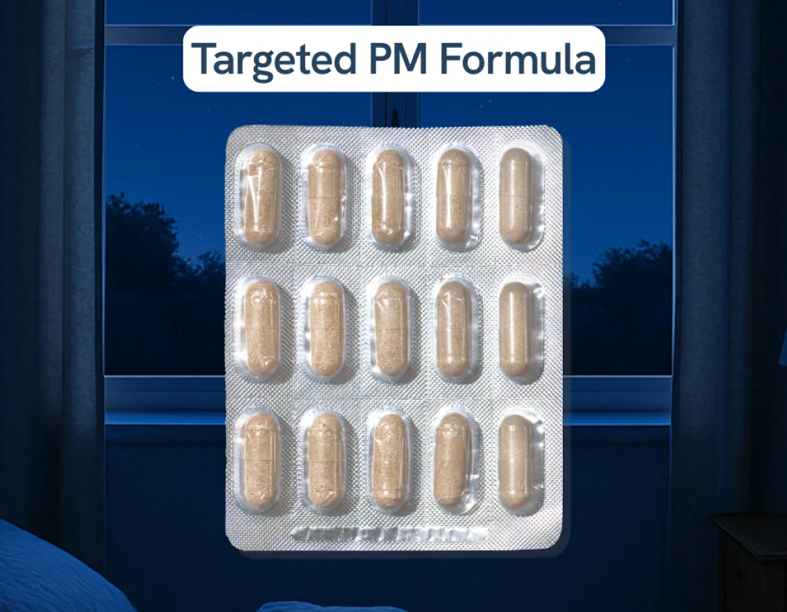 Blister pack of capsules labeled 'Targeted PM Formula' in front of a window at night.