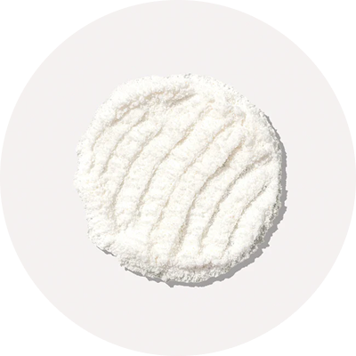 White textured circular pad on a light background.