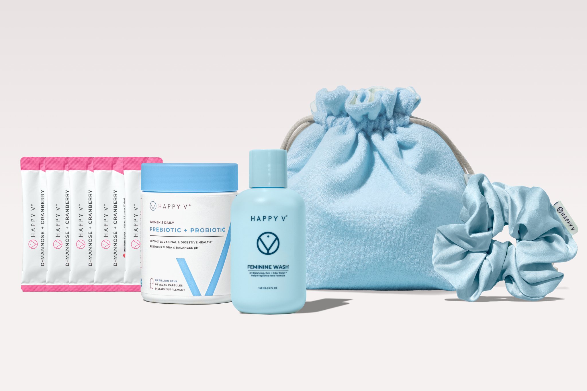 An arrangement of Happy V brand women's health products, including supplements, a wash, a bag, and a scrunchie.