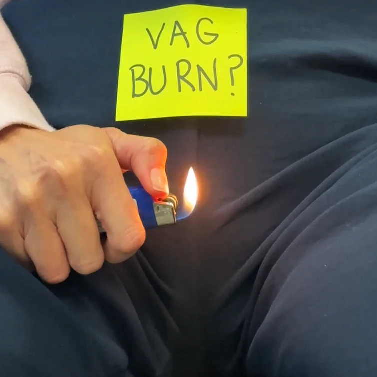 Modern white bathroom with a toilet on fire, emitting flames and ashes.