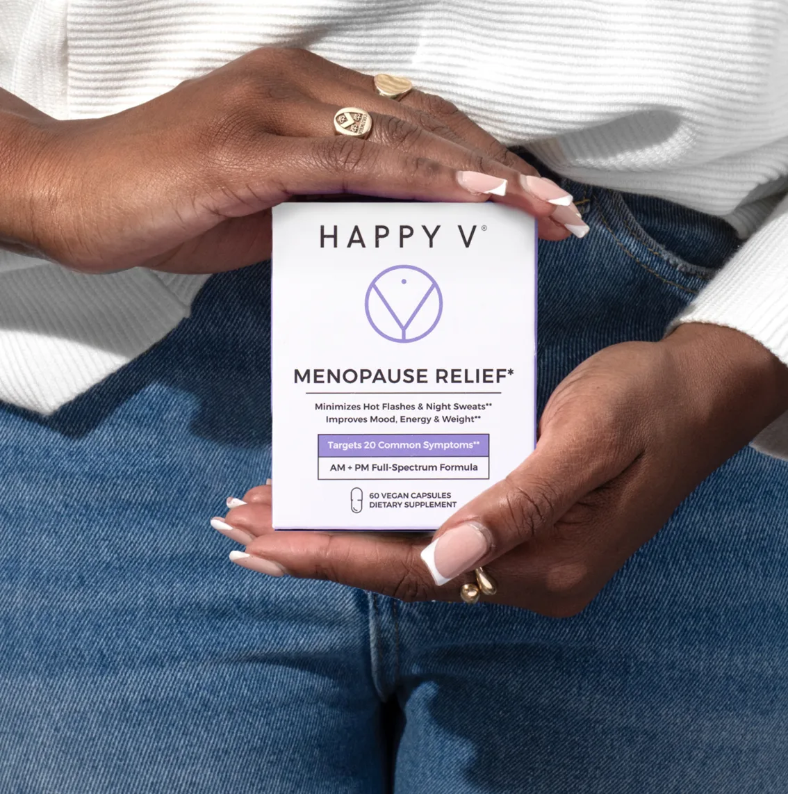 Hands holding a box labeled 'Menopause Relief' dietary supplement.
