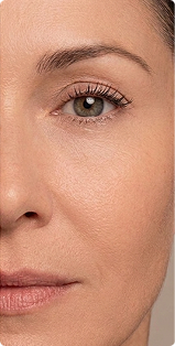 A close-up shot of the left side of a woman's face, showing her eye, cheek, and nose.