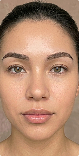 A close-up, front-facing portrait of a woman with light brown eyes and dark, well-defined eyebrows.