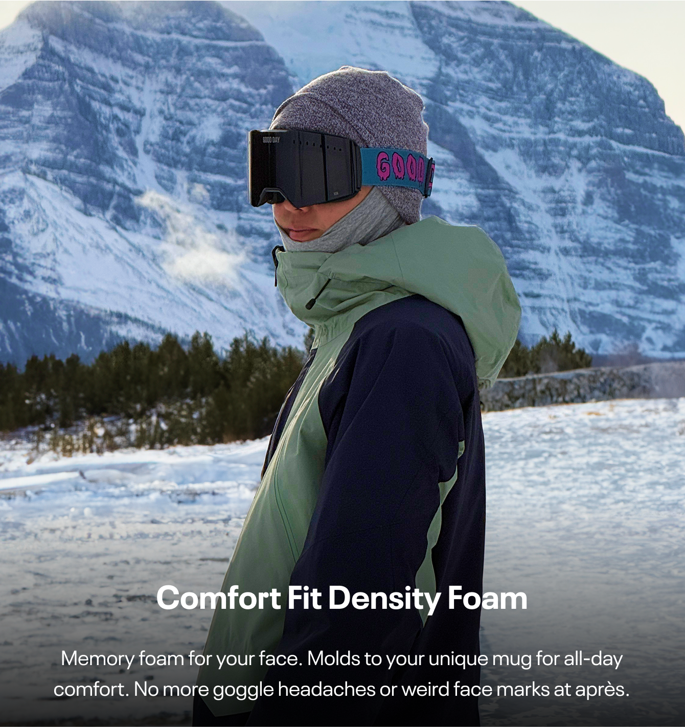 Person wearing ski goggles and winter clothing in snowy mountain landscape.