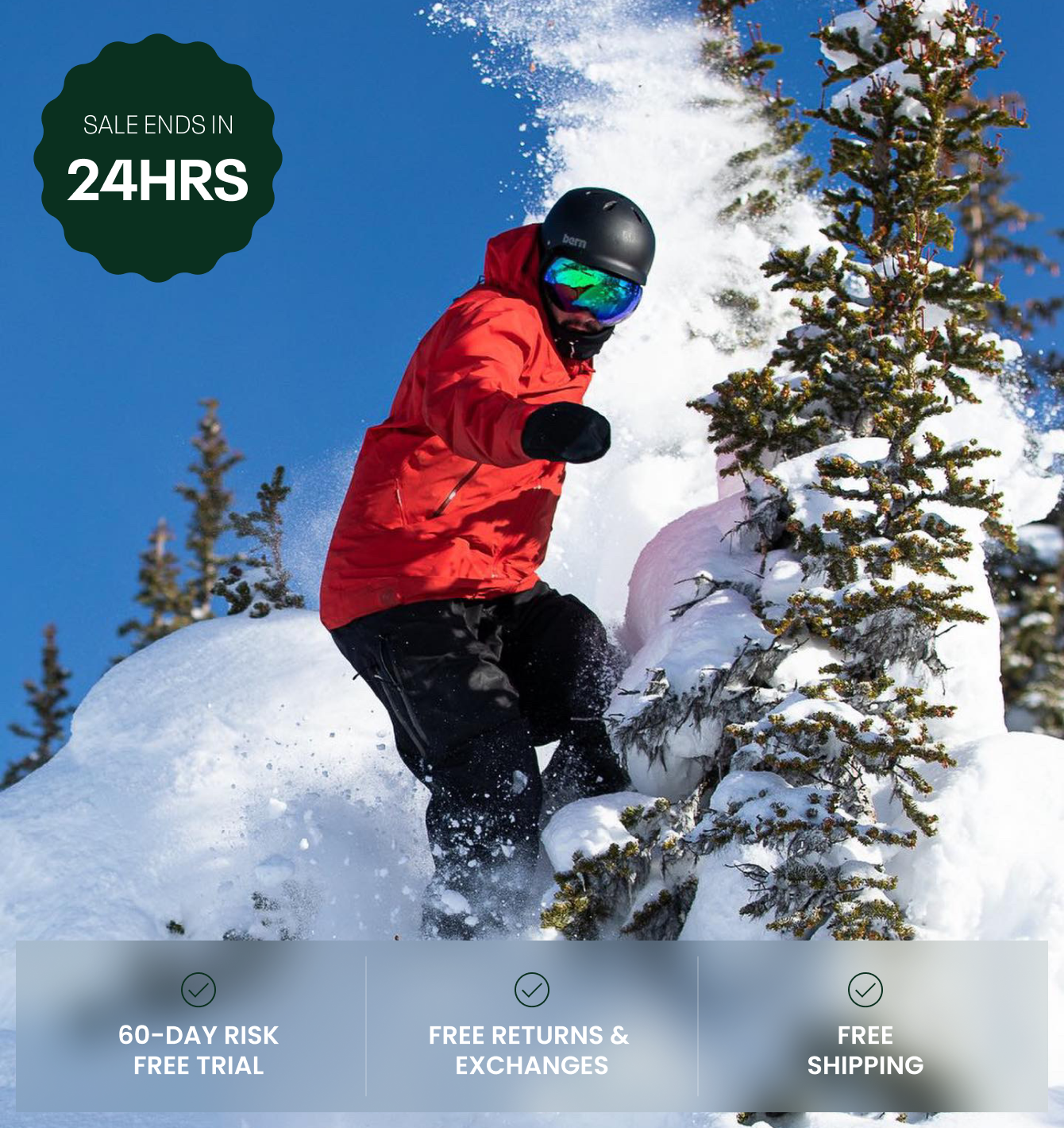 Snowboarder in red jacket riding through snow-covered trees.