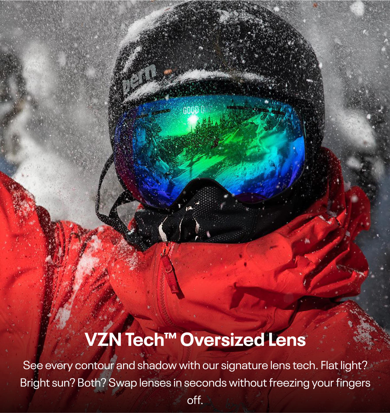 Person in red jacket and helmet with reflective ski goggles in snowy environment.