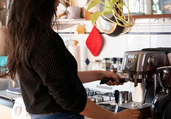Image of a person pulling a shot of espresso with a home espresso machine.