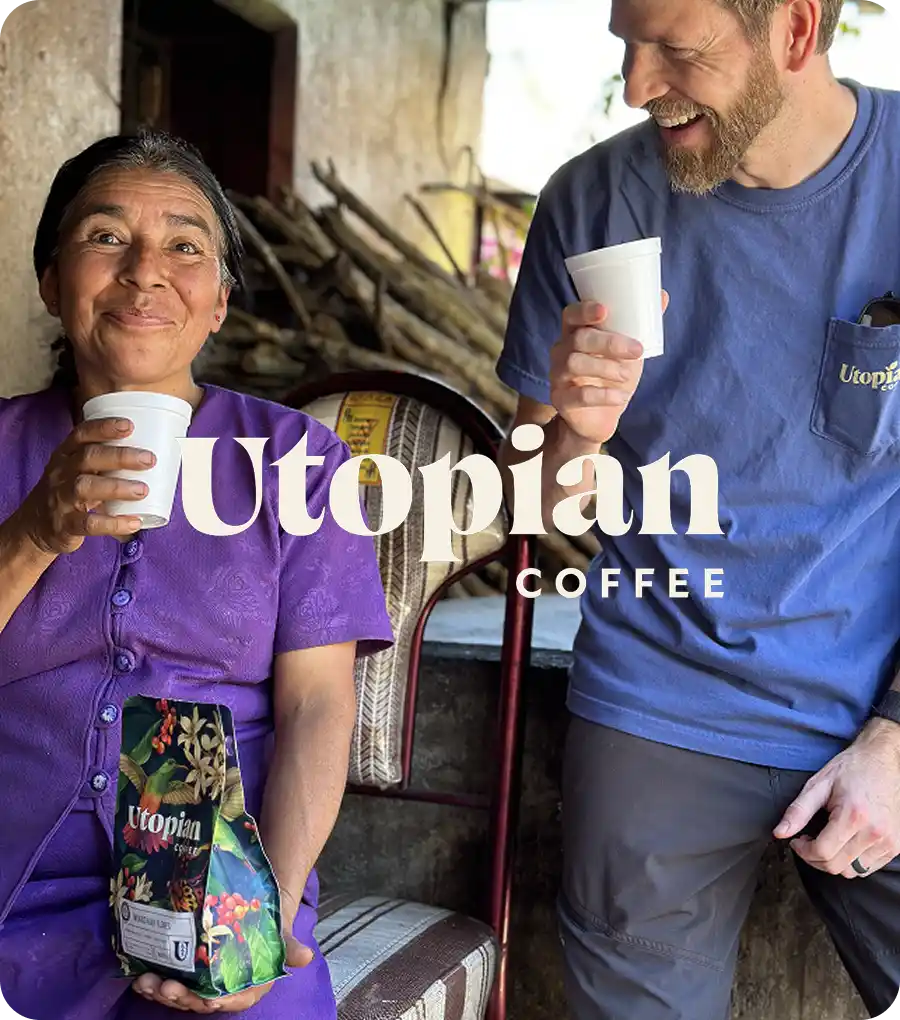 Utopian team drinking a cup of coffee with a coffee producer.