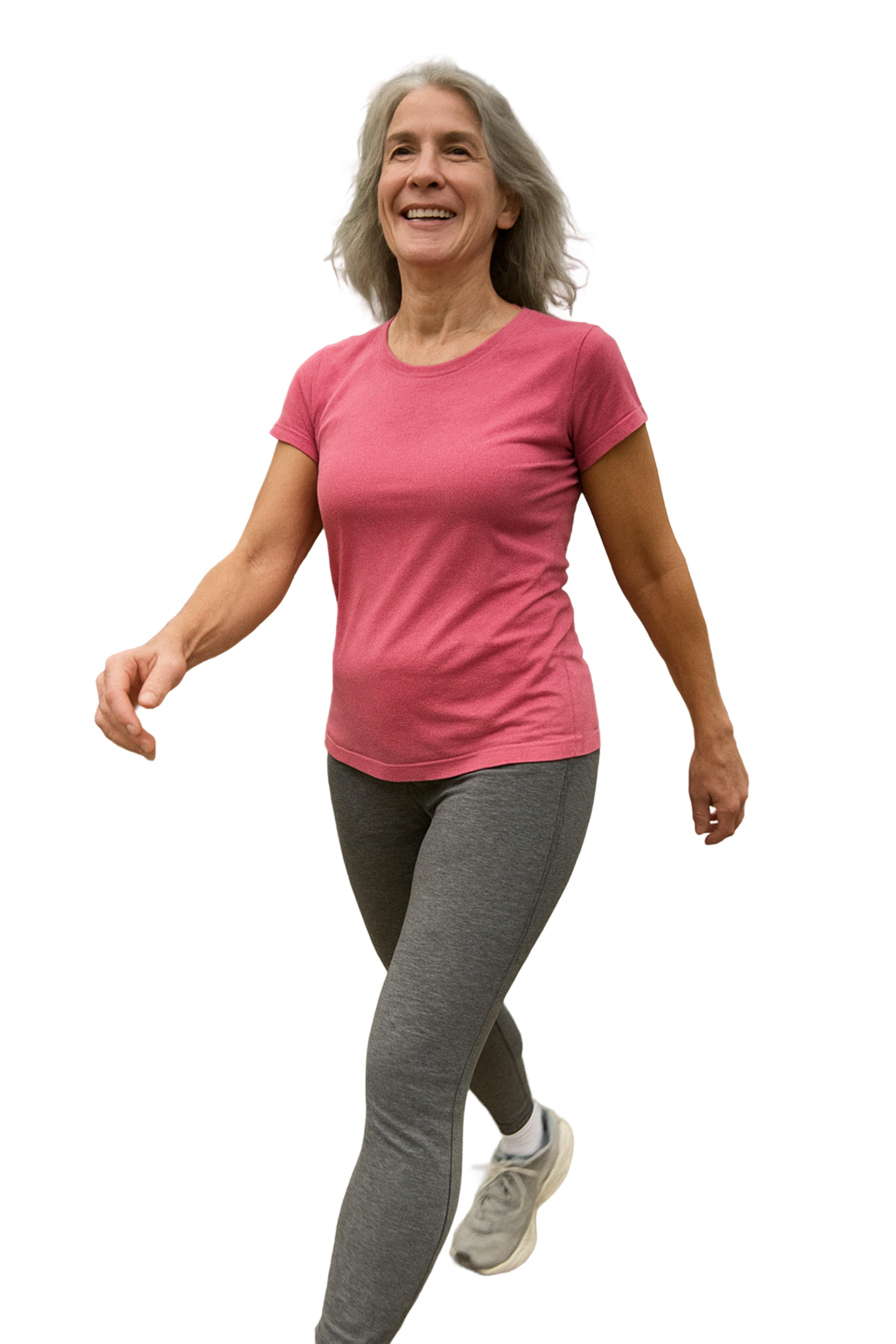 Woman in pink shirt and gray leggings walking, smiling.