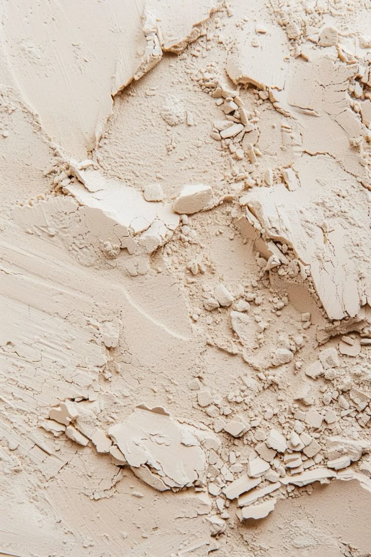 Close-up of crumbled beige powder on a textured surface.