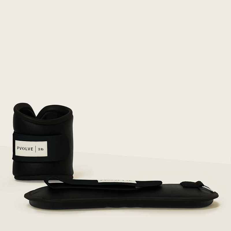 A pair of black 3 lb Pvolve ankle weights, one fastened upright and the other lying flat.