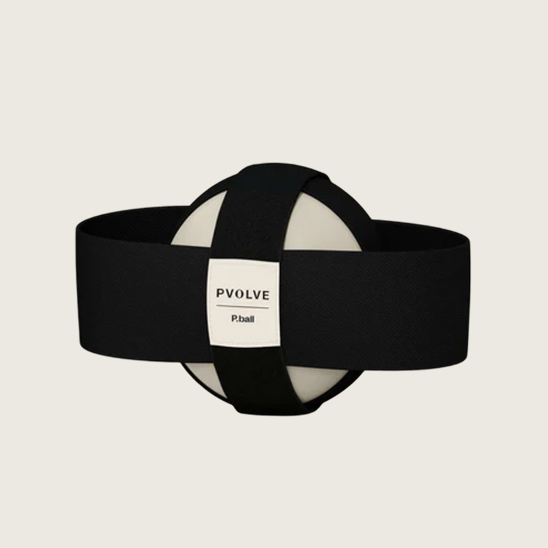 The Pvolve P.ball, a cream-colored exercise ball held in a black strap harness.