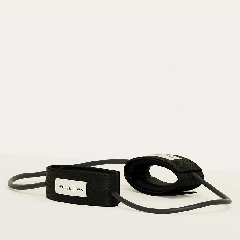 A black Pvolve heavy resistance band with two padded ankle cuffs on a white surface.
