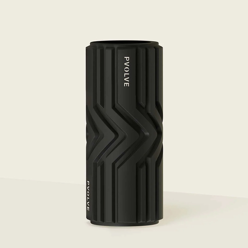 A black Pvolve foam roller with a geometric texture standing upright against a light background.
