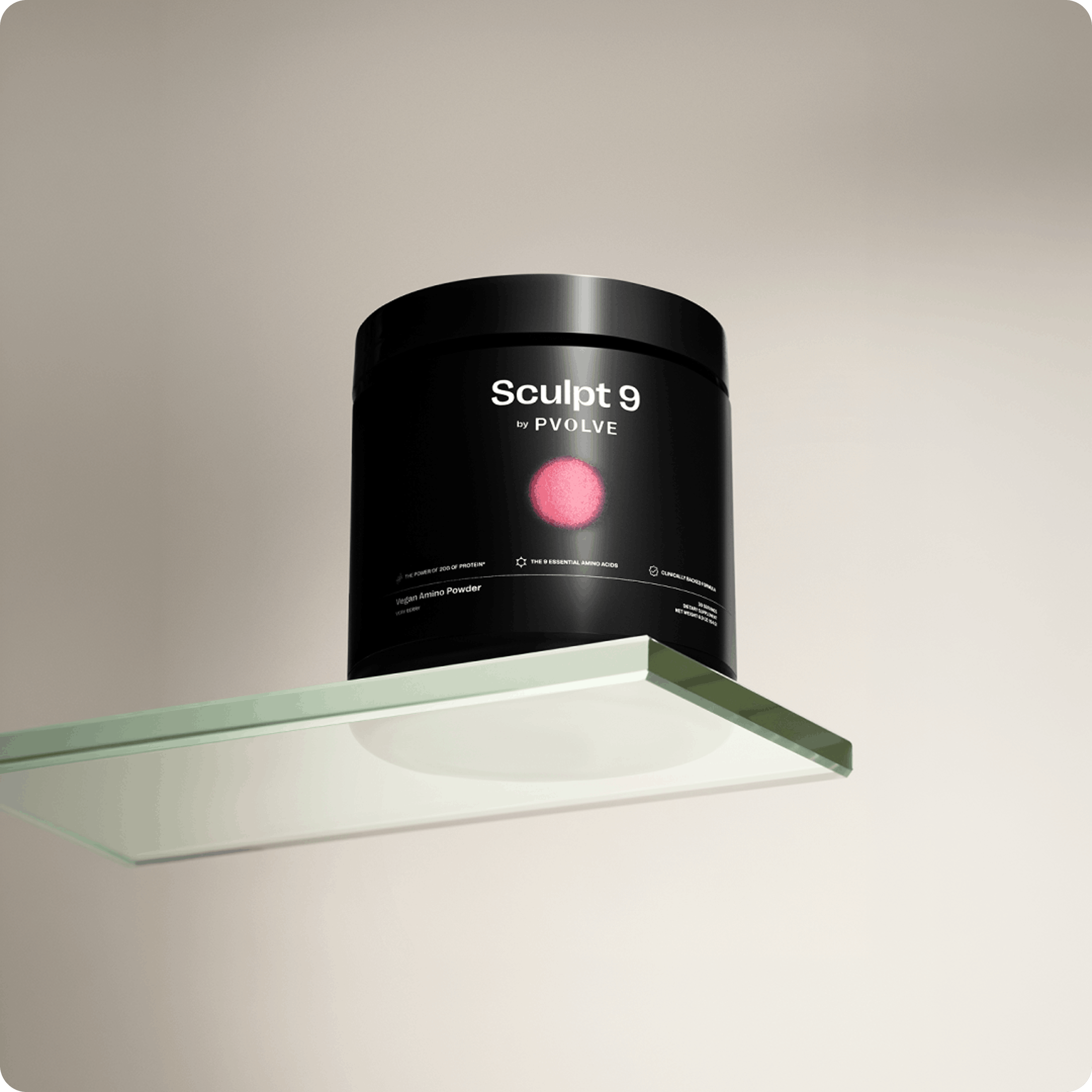 A black tub of Sculpt 9 by Pvolve Vegan Amino Powder sits on a glass shelf.