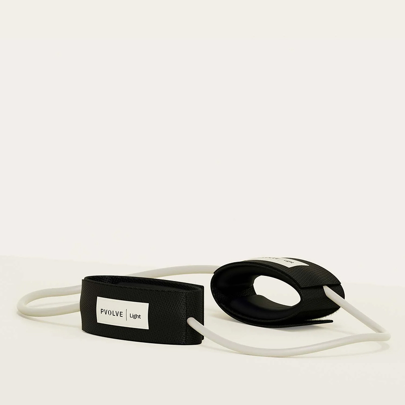 A P.volve light resistance band with two black ankle cuffs, resting on a white surface.
