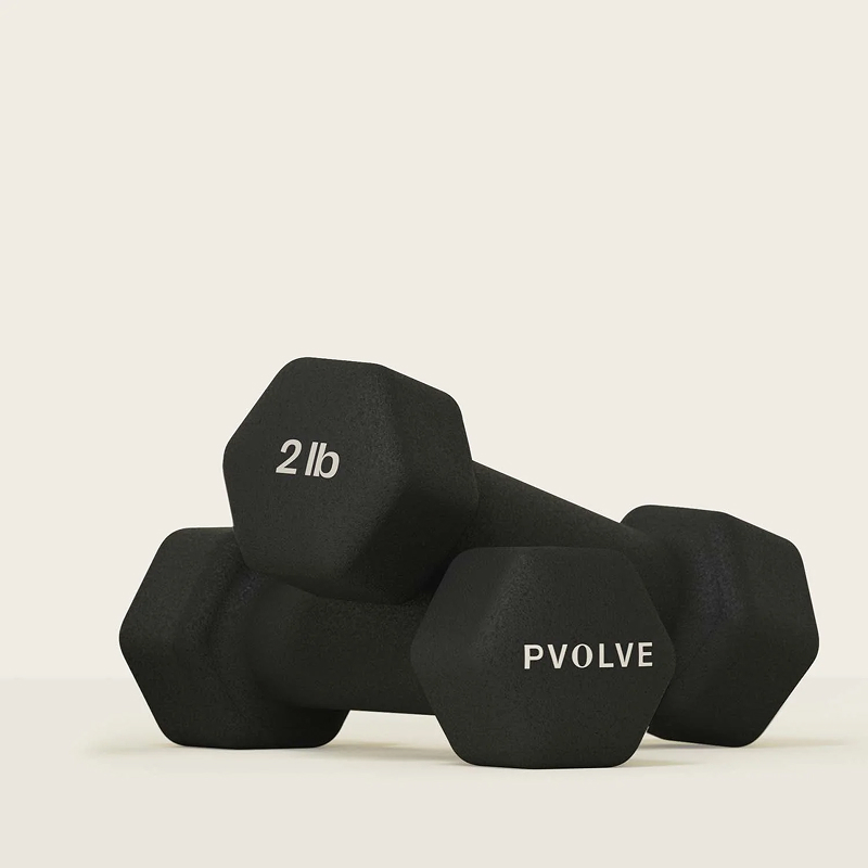 A pair of black, hexagonal 2 lb dumbbells from Pvolve on a light background.