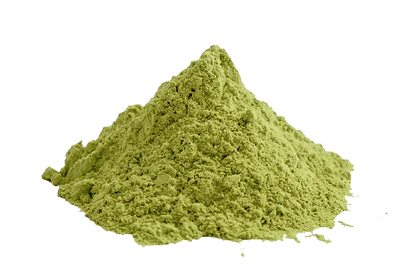 A pile of white powder sits on a white surface next to a cracked fruit pod spilling out chunks.