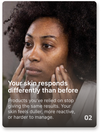 A Black woman with natural curly hair gently touches her cheeks with both hands.