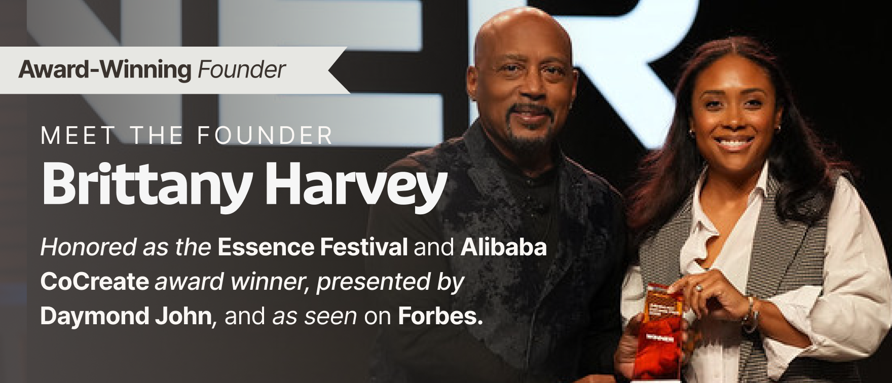 Daymond John presents an award to founder Brittany Harvey on stage.