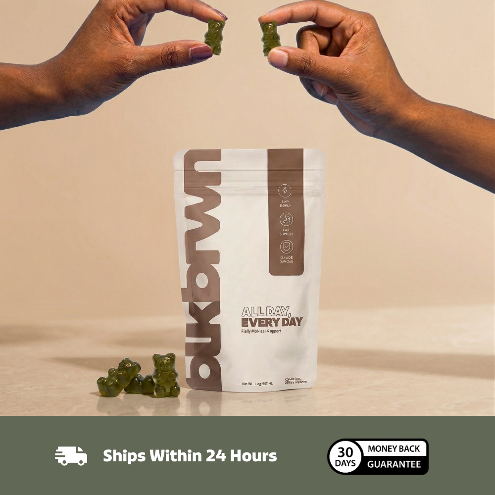 Two hands hold green gummy bears above a white pouch of blkbwn 'All Day, Every Day' supplements.